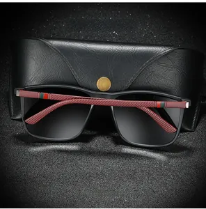 Close-up of polarized sunglasses with black matte frame and textured red temple detail