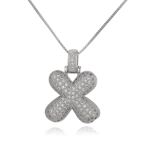 Macro view of silver X-shaped pendant necklace with cubic zirconia pave settings