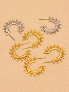 Detailed top view of C-shaped sunflower earrings in gold and silver polished finishes