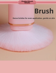 Macro detail of dense pink gradient bristles and gold-trimmed matte base of the makeup brush