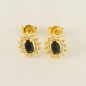 Detail of gold sunflower earrings featuring a black oval zircon center and clear crystals