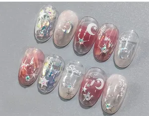 Macro detail of 5D star and moon press-on nails with glitter sequins and colorful rhinestones