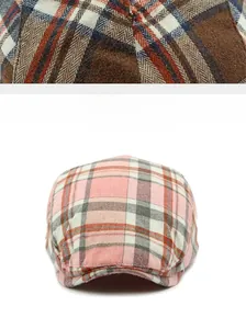Detailed macro view showing the textured wool blend plaid fabric of these newsboy caps