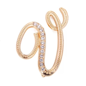 Elegant gold alphabet brooch with rhinestone inlay on a clean white background