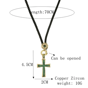 Macro detail of emerald green zircon cross pendant with gold plating and dimensions
