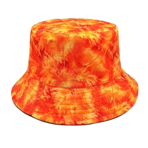 Detail of vibrant orange tie-dye bucket hat with reinforced multi-row stitching on the brim