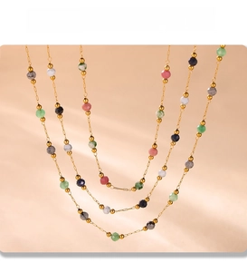 Detail of PVD gold plated double layer necklace with colorful faceted stone beads