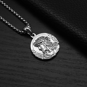 Macro shot of vintage silver steel medallion pendant featuring embossed portrait details