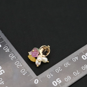 Handmade gold-plated natural pearl earrings with colorful gemstones on a black background