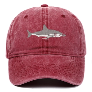Close-up of vintage red washed cotton baseball cap featuring shark embroidery detail