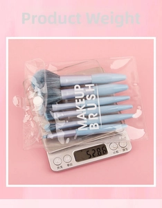 Detailed view of 6-piece blue makeup brush set on scale showing 52.86g weight