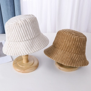 Detailed close-up of corduroy texture on cream and khaki bucket hats for women