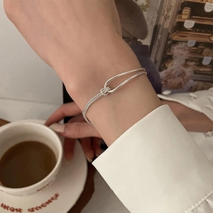Silver chain knot bangle with geometric arc design and minimalist modern style for women