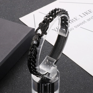 Close-up of black stainless steel curb chain bracelet on a professional display stand