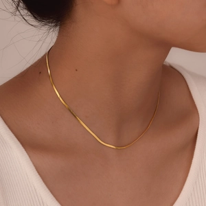 Elegant gold-plated flat snake chain necklace for women featuring a minimalist polished design