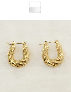 Detail of 18K gold plated U-shaped twist earrings with mixed polished and textured surfaces