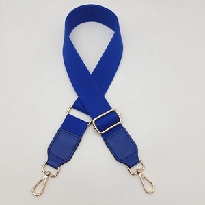 Close-up of royal blue woven strap with gold metal buckle and leather reinforcement