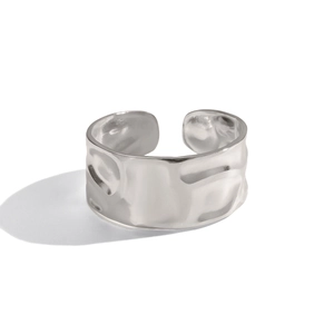 Close-up of a silver irregular wide open ring with modern textured hammered finish