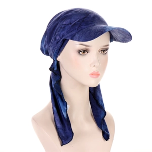 Detail of navy blue tie-dye turban hat with brim and long side straps on white background