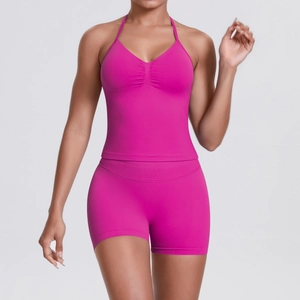 Close-up of hot pink ribbed yoga set with halter V-neck sports top and high waist shorts