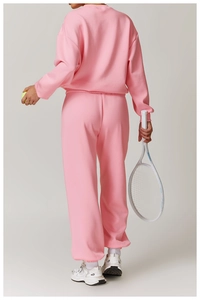 Rückansicht eines rosa Trainingsanzugs mit hoch taillierter Jogginghose und Oversize-Sweatshirt