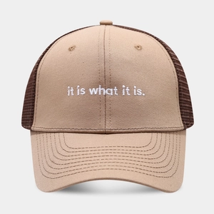 Close-up of the breathable mesh back and white 'it is what it is' embroidery on the trucker hat