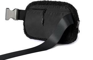 Close-up of black plush fleece and nylon material mix with metal buckle on waist bag