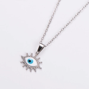 Close-up of silver stainless steel necklace with sunburst oval evil eye pendant detail