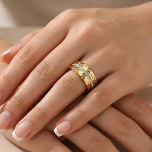 Hammered gold titanium steel ring with full white zircon inlay worn on a female finger