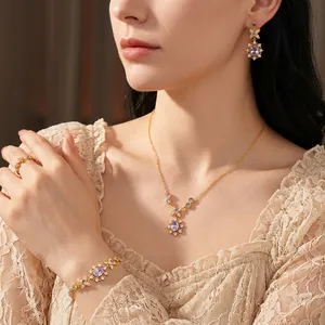 Vintage gold jewelry set with purple gemstones and zircons featuring necklace and earrings