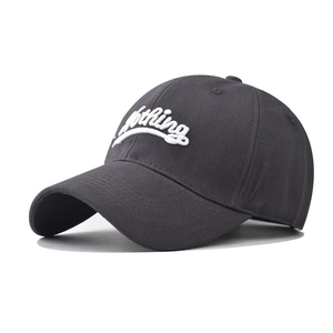 Detailed view of white 3D 'Nothing' embroidery on a dark grey cotton baseball cap