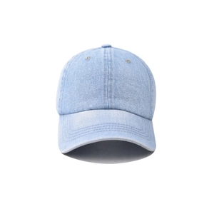 Detail of light blue washed denim baseball cap with classic 6-panel crown and top button