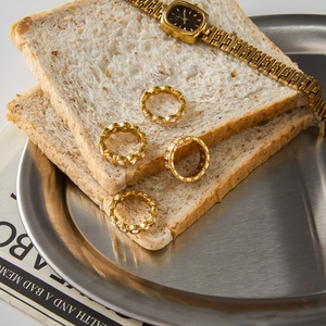Classic 18K gold stainless steel heart rings with zircon stones displayed on bread