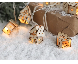 Close-up of lighted wooden house fairy lights for warm Christmas home decorations