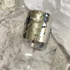 Detailed view of silver metallic lava texture hair clip on a clear glass plate