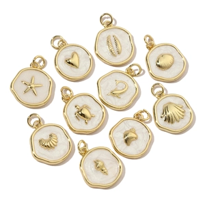Golden ocean charms with white enamel featuring starfish turtle and dolphin shapes