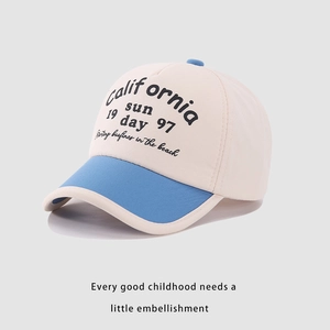 Detail of California Sun print on a two-tone kids baseball cap with blue brim