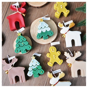 Flat lay of handmade Christmas candles in reindeer, tree and gingerbread man shapes