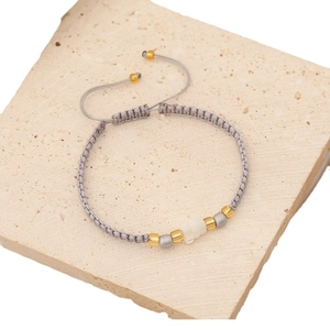 Handmade woven seed bead bracelet with shell charms in grey and gold tones