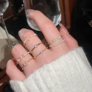 Close-up of luxury gold-plated ring set with pearls and zircon on model hand