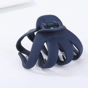 Close-up of a matte dark blue octopus hair claw clip with a strong metal spring mechanism