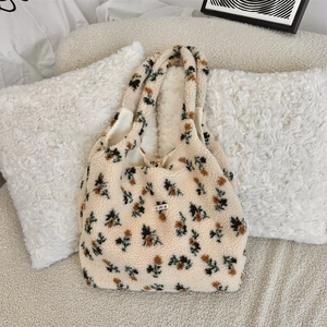 Close-up of soft plush tote bag with flower pattern and brand label detail