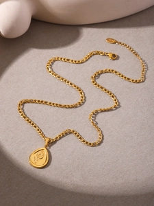 Detail of 18K gold-plated teardrop pendant with engraved sunflower and butterfly patterns