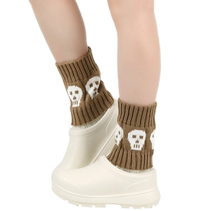 Brown knitted leg warmers with white skull patterns for autumn and winter outfits