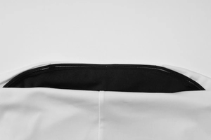 Detail shot of black zipper closure and contrasting fabric stitching on white tube top
