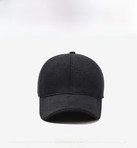 Detail of dark grey baseball cap with metal Sports logo and thick wool-like fabric texture