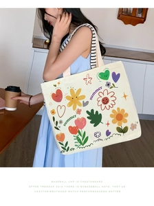 Detail of canvas tote bag with colorful summer flowers and sweet heart illustration