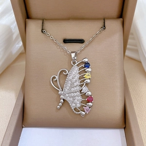 Detailed shot of titanium steel butterfly pendant with colorful gemstones and pavé crystals