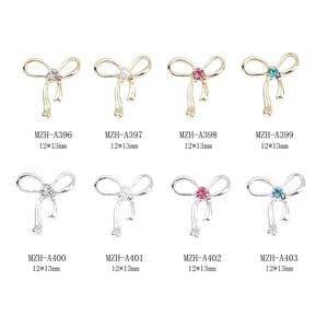 Hollow alloy bowknot nail art charms with rhinestones and pearls in gold and silver