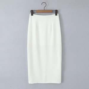 Close-up of white high-waist pencil skirt with lace embroidery and pleated details